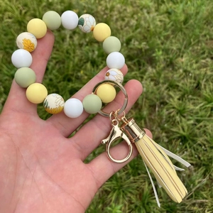 Bracciale portachiavi in perline di silicone con stampa a margherite e nappa in PU