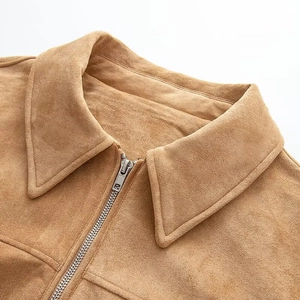 Close-up of brown faux suede bomber jacket showing metallic zipper and fabric texture