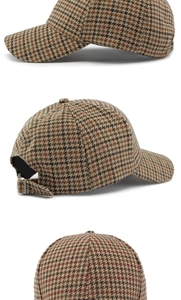 Detail of houndstooth baseball cap showing woven fabric and adjustable metal buckle
