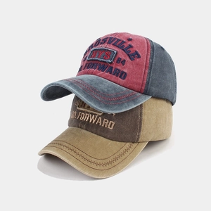 Detail of vintage washed baseball caps with high-density embroidery and contrast stitching