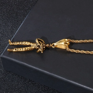 Macro shot of gold soldier shooting pendant on a black textured jewelry display case