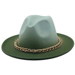 Detail of wide brim fedora hat with gradient green felt and golden metal chain link