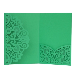 Detailed laser-cut green paper invitation cover with intricate decorative patterns