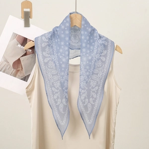 Classic blue paisley bandana scarf styled on a beige top for a retro American aesthetic