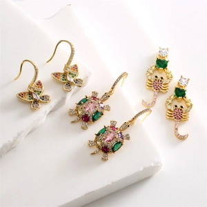 Exaggerated gold earrings set with butterfly turtle and scorpion colorful zircon