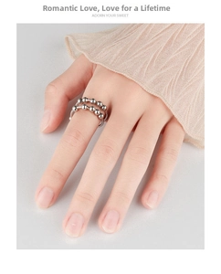 Detail view of adjustable silver spinner rings with rotating beads for stress relief