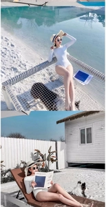 Detail view of white long sleeve one-piece swimsuit with high cut design for beach resort wear