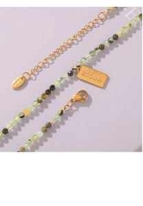 Detail of stainless steel lobster clasp and heart tag engraved with Love on stone necklace