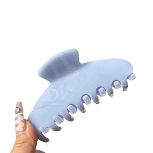 Handheld light blue marble acetate hair claw clip with glossy finish for women