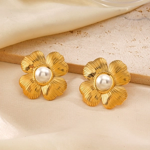 Elegant 18K gold plated flower stud earrings with white pearl centers on silk fabric