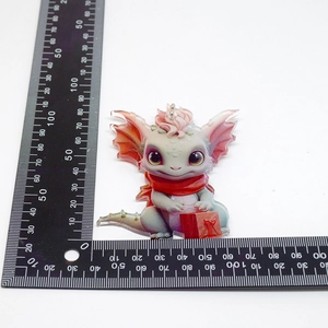Detailed view of a Christmas dragon acrylic pendant with size ruler measurements