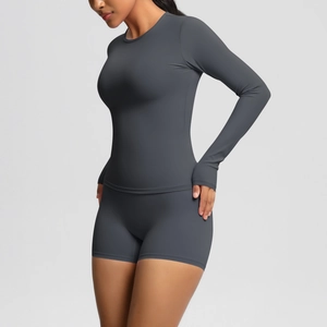 Detail view of grey yoga set featuring thumbhole sleeves and high-waist sports shorts