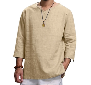 Detailed close-up of light khaki cotton linen shirt fabric with minimalist V-neck design