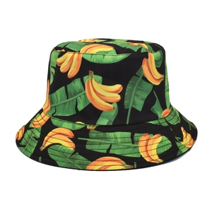 Black bucket hat with yellow banana and green palm leaf print in a summer style