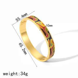 Detail view of gold enamel bangle with 55.4mm inner diameter and 10mm width measurements
