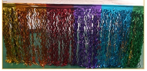 Close-up of vibrant rainbow gradient foil fringe table skirt for party decorations