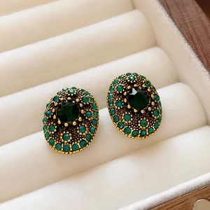 Vintage oval emerald crystal earrings in gold-tone metal setting on velvet box