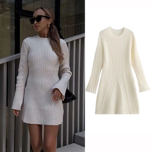 Detail view of cream ribbed knit mini dress featuring a crew neck and flared long sleeves