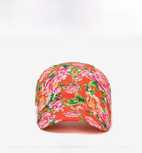 Detail of red floral newsboy cap with traditional peony print and structured stitching