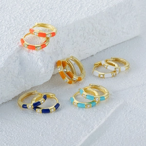 Macro shot of colorful enamel and diamond S925 silver hoop earrings in various colors