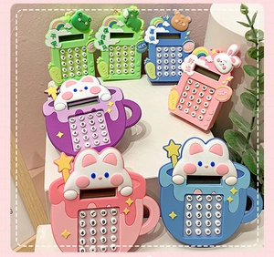 Detail of colorful cartoon calculator keychains in frog, bear, and rabbit shapes
