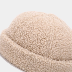 Beige faux shearling brimless beanie with soft teddy fleece texture and thick rolled cuff