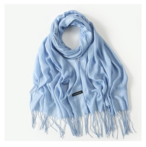 Detail view of blue cashmere scarf fringe and black label with white text