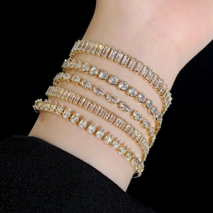 French luxury gold tennis bracelet set with sparkling zircon stones worn on model wrist