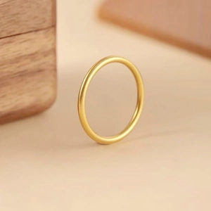 Macro shot of gold minimalist matte finish ring with elegant four-leaf clover detail