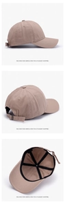Detail of khaki cotton baseball cap showing metal buckle strap and inner sweatband