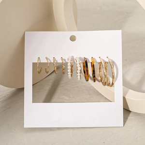 Minimalist earring set with 5 pairs featuring hoops, pearls and acrylic tortoiseshell texture