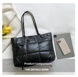 Detailed top view of quilted black down tote bag with spacious interior and soft nylon fabric
