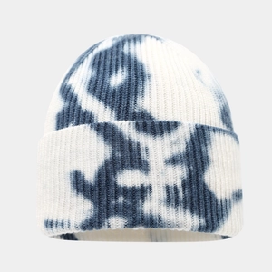 Blue and white tie-dye knit beanie featuring a thick ribbed texture for winter warmth