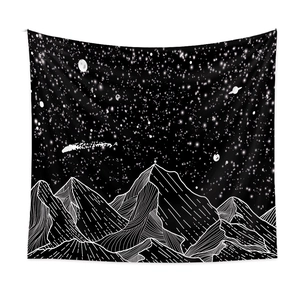 Detailed view of the black and white mountain tapestry featuring stars and moon patterns