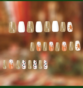 Macro detail of Christmas coffin press-on nails with gingerbread and candy cane art