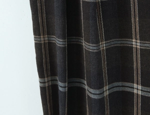 Detailed macro view of woven plaid fabric texture in brown, blue and yellow tones