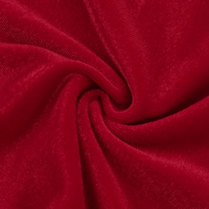 Detailed macro view of plush red velvet fabric texture with elegant light reflections