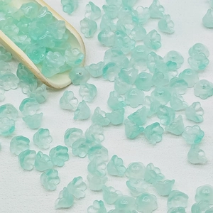 Detail of mint green lily of the valley glass beads for handmade jewelry DIY projects