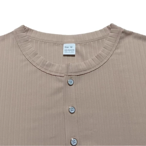 Detail view of V-neck neckline with three buttons and size tag on men ribbed knit shirt