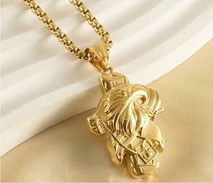 Close-up of golden Desert Eagle cross pendant on luxury silk background