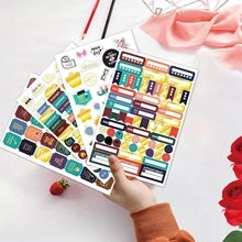 Detailed view of functional schedule stickers with colorful icons for daily planning