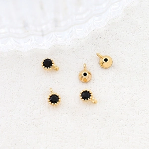 Detailed view of 18k gold plated charms with black zircon stones and secure hanging loops