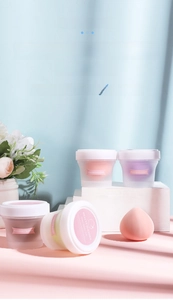 Close-up of peach beauty sponges in individual frosted jars for flawless makeup application