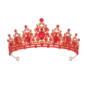 Exquisite detail of golden bridal crown featuring vibrant red crystals and teardrop stones