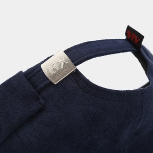 Macro detail of navy blue velvet brimless cap with silver metal buckle and woven logo label