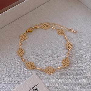 Detailed macro view of the gold-plated four-leaf clover hollow bracelet in a jewelry box