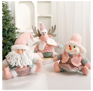 Detailed knit texture on pink and grey Santa, reindeer, and gnome Christmas plush dolls
