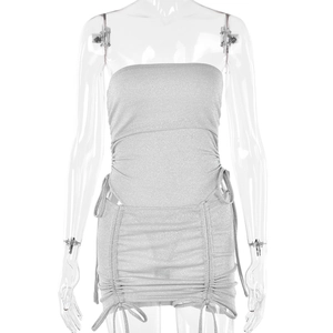 Detail of silver glittering two-piece set featuring side drawstring ruched mini skirt
