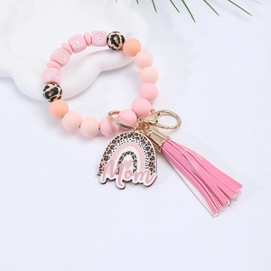 Detail of silicone beaded keychain with LOVE beads, pink tassel, and Mom charm pendant