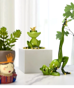 Macro view of a pair of creative green yoga frog resin figurines for home decor